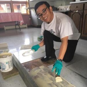 Peter Nguyen works on flooring