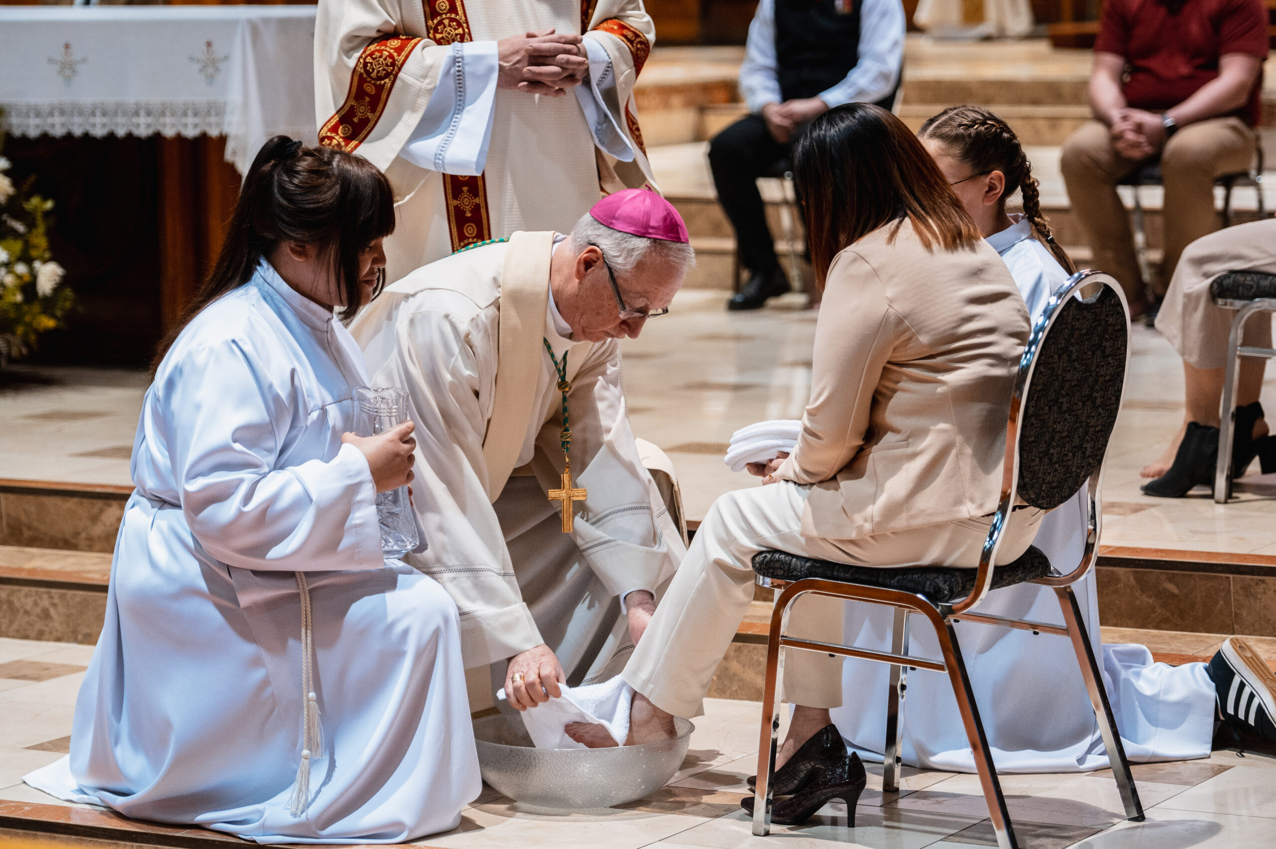 Archbishop Smith washes the feet of 12 representatives, just as Christ washed the feet of the 12 disciples.