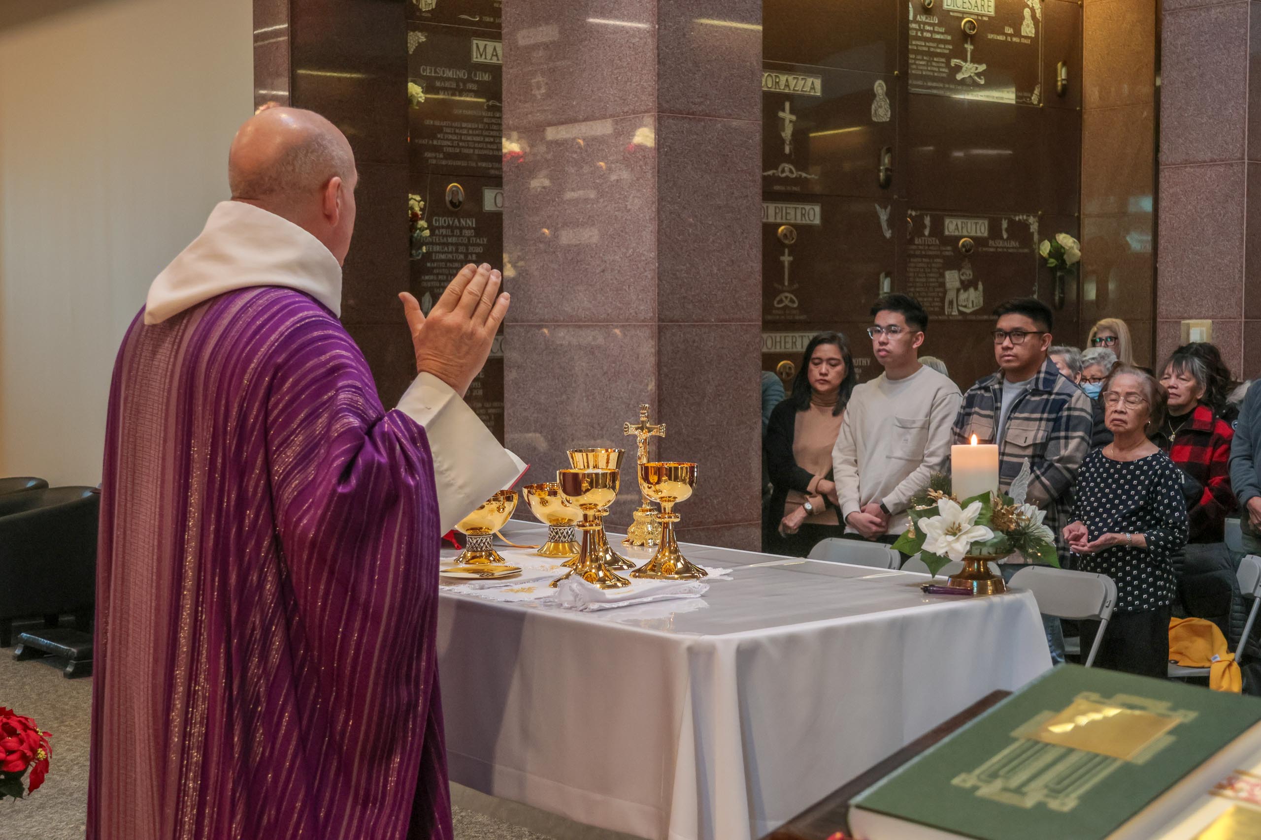 Families remember loved ones during Advent Mass at Holy Cross Cemetery ...
