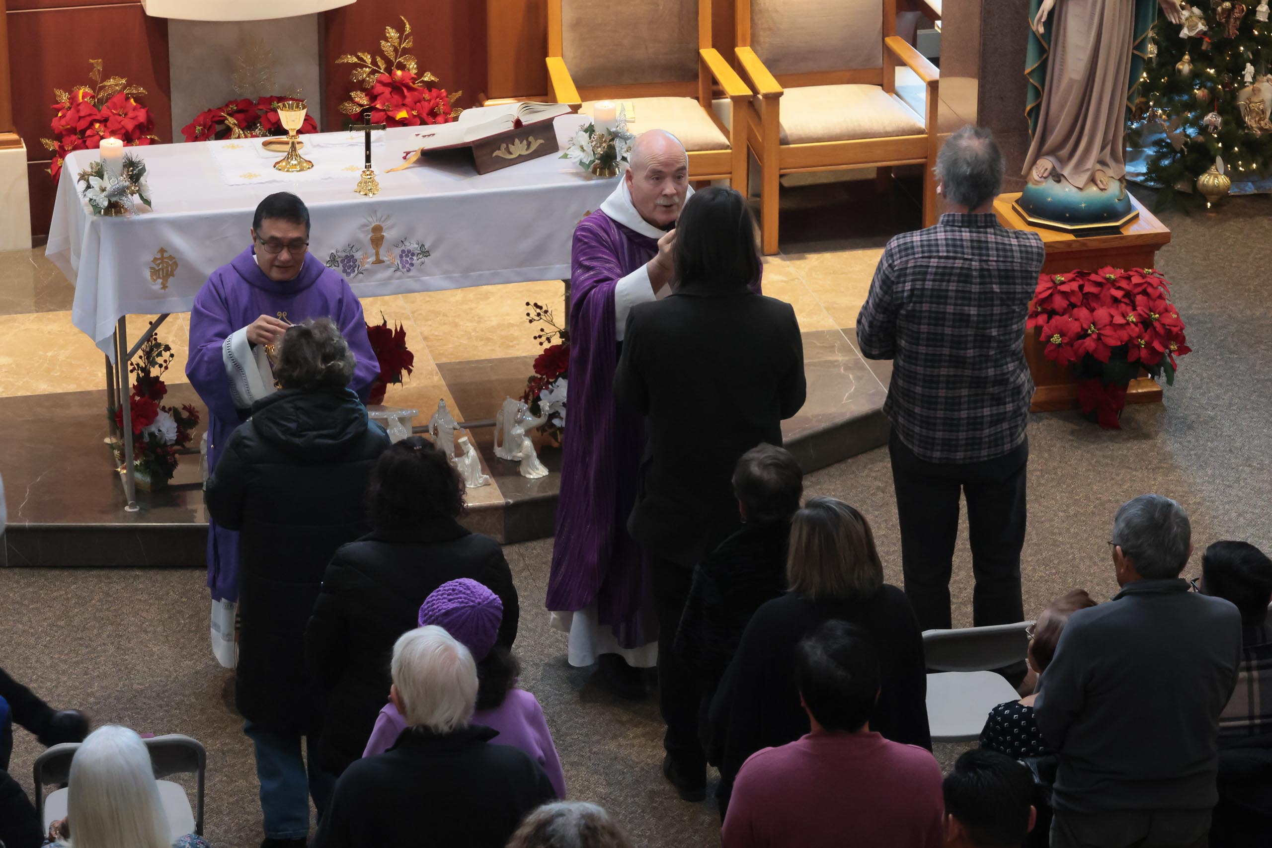 Families remember loved ones during Advent Mass at Holy Cross Cemetery ...