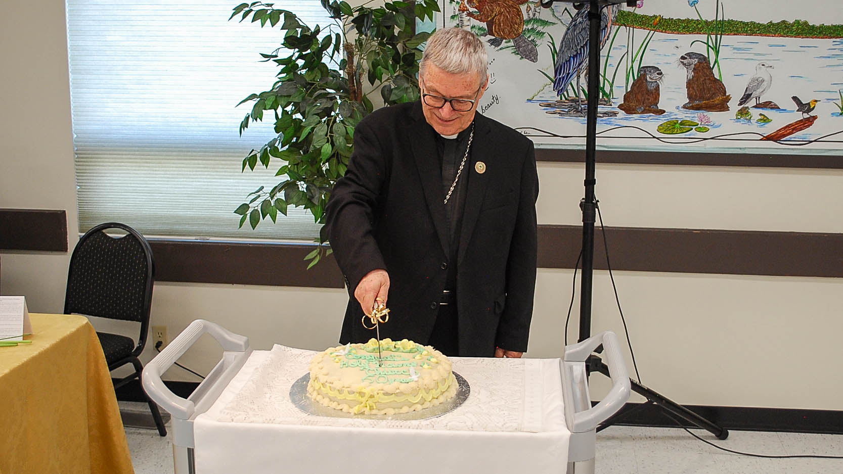 Bishop Paul Cuts The Jubilee Cake To Share The Joy Of The Occasion